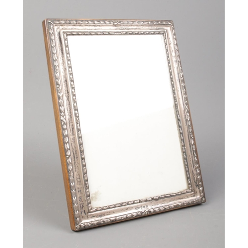 455 - A silver mounted photo frame on easel back. (17cm x 12.5cm). Assayed for Birmingham, 1968, by W I Br... 