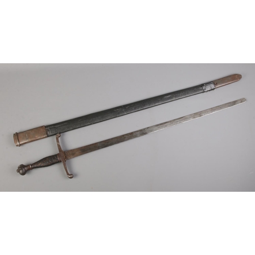 459 - An antique sword featuring crown pommel and stamped twin scrolled cross guard, with scabbard. Blade ... 