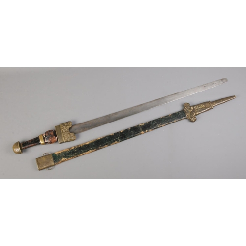 460 - An antique German Migration style sword with plain blade, painted wooden handle and stamped twin lio... 