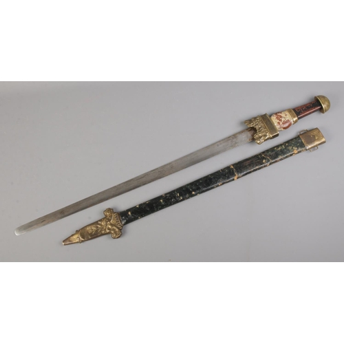 461 - An antique German Migration style sword with plain blade, painted wooden handle and stamped twin lio... 