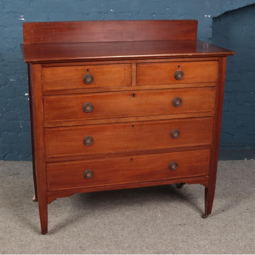 473 - A mahogany set of two over three drawers featuring banded inlay detail and raised on castors. Approx... 