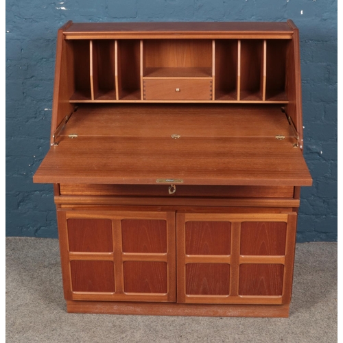 476 - A mid-century modern Parker Knoll teak bureau with single drawer and pair cupboard doors, on plinth ... 