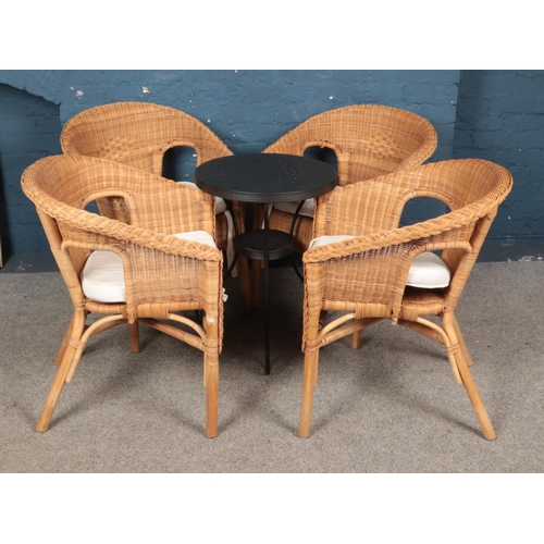 479 - Four rattan tub chairs along with tin garden table.