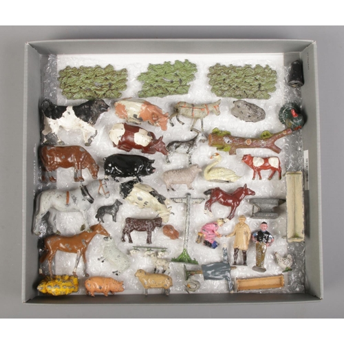 94 - A collection of approximately 40 lead farmyard figures and accessories. Includes some examples stamp... 