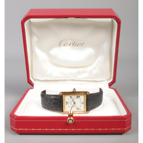 101 - A Must De Cartier silver gilt tank watch, model 2413. Having date display, Roman numeral markers and... 