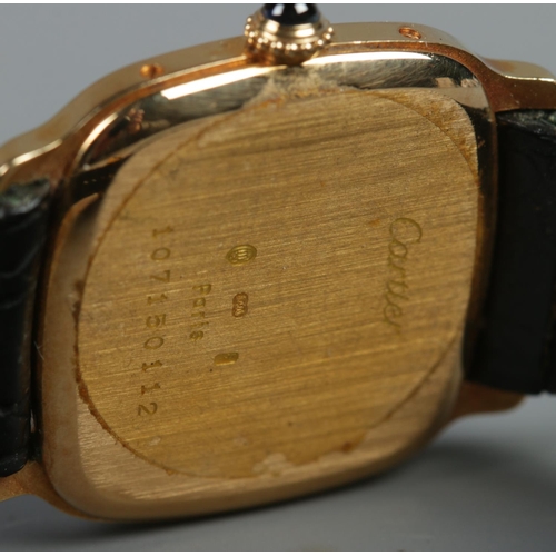 102 - An 18ct gold Cartier manual wristwatch. Having Roman numeral markers. With leather strap and 18ct go... 