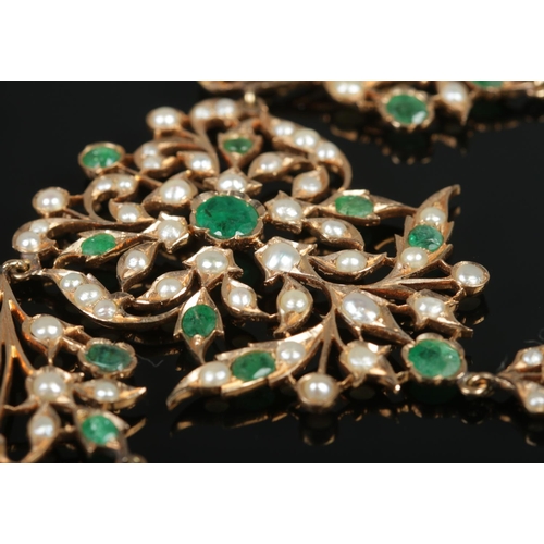 103 - A gold, emerald and seed pearl necklace of bib form, having reticulated sections. Tests from 14ct to... 