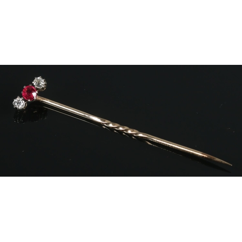 116 - A Victorian yellow metal, diamond and ruby coloured stone stick pin.