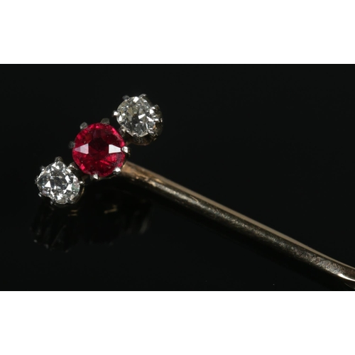 116 - A Victorian yellow metal, diamond and ruby coloured stone stick pin.