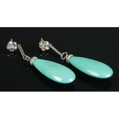 122 - A pair of white metal, diamond and turquoise drop earrings. Size of stone (with white metal mount) 3... 