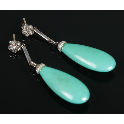 122 - A pair of white metal, diamond and turquoise drop earrings. Size of stone (with white metal mount) 3... 