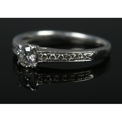 127 - A platinum and diamond ring. The central stone (approximately 0.36ct) flanked by six stones to each ... 