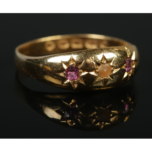 130 - A Victorian 22ct gold three stone ring set with two pink rubies and a seed pearl. Assay marks for Sh... 