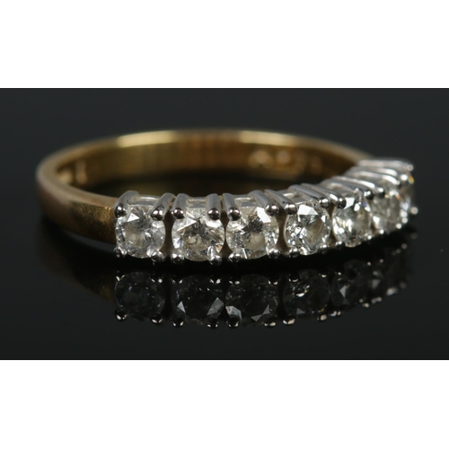 132 - An 18ct gold seven stone diamond ring. Size M 1/2. 3.56g. Approximately diamond 0.75ct in total.