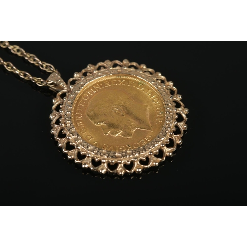 139 - A George V full sovereign, dated 1911 in 9ct gold mount on 9ct gold chain. 14.89g.