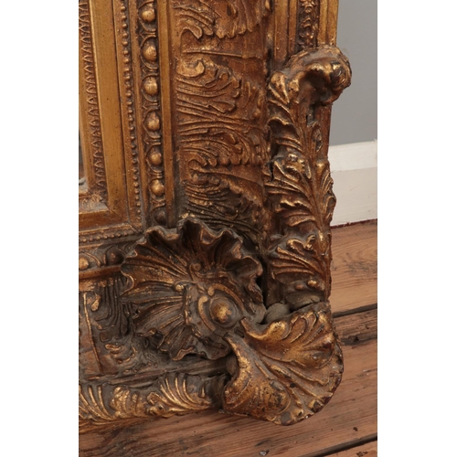 164 - A very large gilt wood framed rococo style bevel edge wall mirror. 121cm x 151cm.