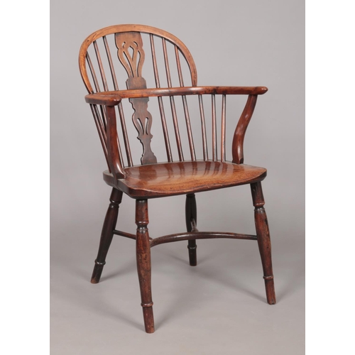 165 - A 19th century ash/elm and yew wood Windsor arm chair with crinoline stretcher. Height of back 88cm,... 