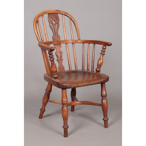 167 - A 19th century child's ash/elm and yew wood Windsor arm chair with crinoline stretcher. Height of ba... 