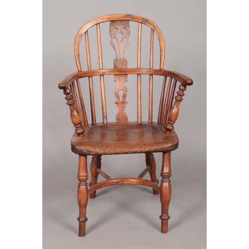 167 - A 19th century child's ash/elm and yew wood Windsor arm chair with crinoline stretcher. Height of ba... 