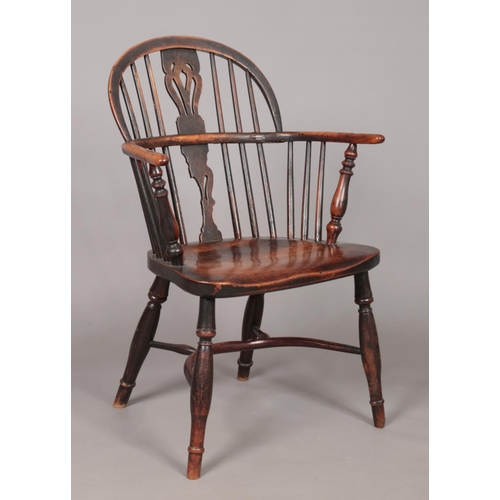 168 - A 19th century ash/elm and yew wood Windsor arm chair with crinoline stretcher. Height of back 86cm,... 