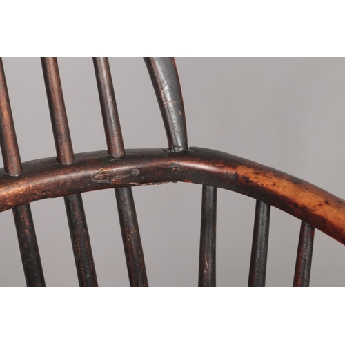 168 - A 19th century ash/elm and yew wood Windsor arm chair with crinoline stretcher. Height of back 86cm,... 