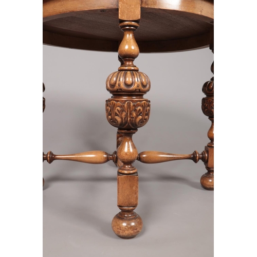 173 - An oak and mahogany circular occasional table with pineapple supports and turned stretcher. Height 5... 