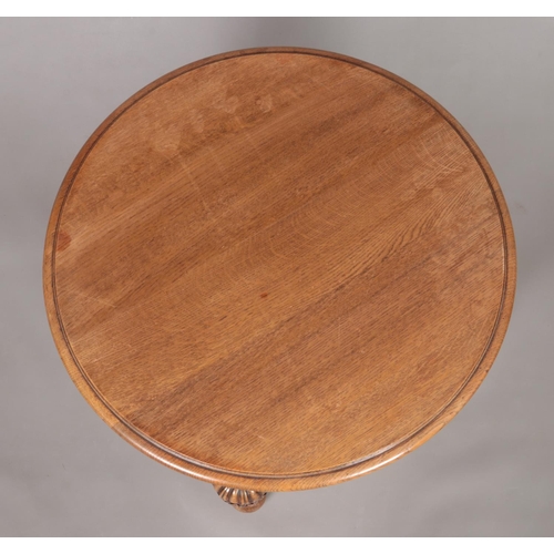 173 - An oak and mahogany circular occasional table with pineapple supports and turned stretcher. Height 5... 