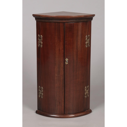 176 - A small Georgian mahogany corner cupboard. Height 68cm, Depth from back corner to front centre 30.5c... 