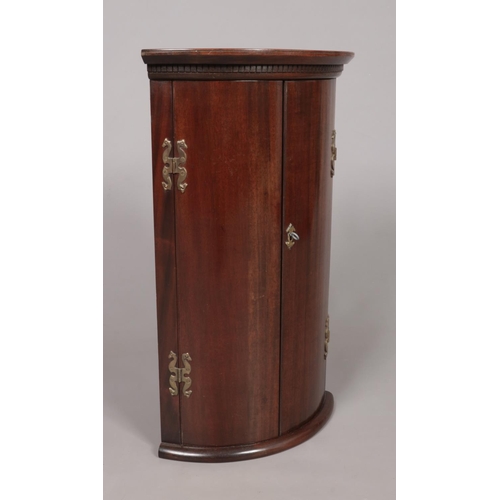 176 - A small Georgian mahogany corner cupboard. Height 68cm, Depth from back corner to front centre 30.5c... 