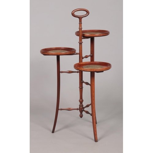 178 - An Edwardian mahogany three tier cake stand, with satinwood crossbanding and turned supports. Height... 