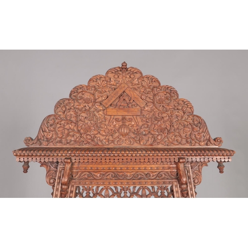 179 - A large easel with extensively carved floral decoration. Height 180cm.