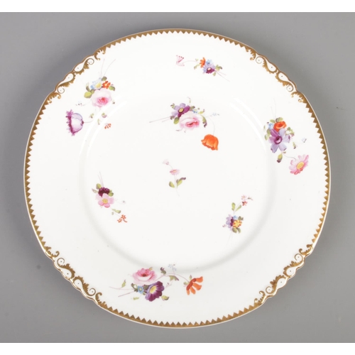 20 - A Rockingham plate decorated with hand painted flowers and gilt border. Red griffin mark C1826-1830.... 