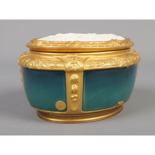 25 - A French Art Nouveau gilt bronze mounted porcelain powder bowl and cover by Paul Louchet, Paris. The... 