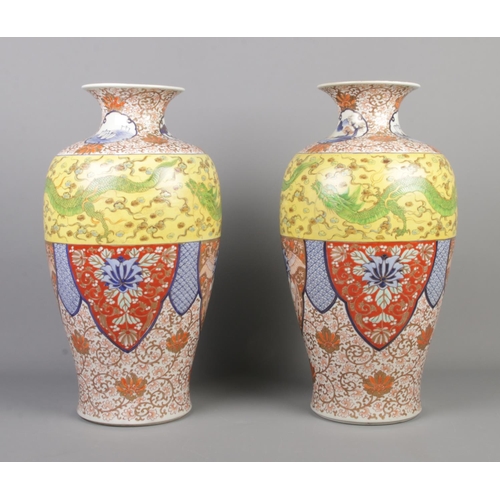 3 - A large pair of Japanese Meiji period baluster shaped vases. Decorated in the Imari style with drago... 