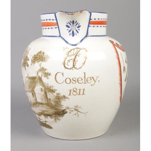 33 - An early 19th century creamware jug featuring various tool motifs and cottage scene, marked Coseley ... 