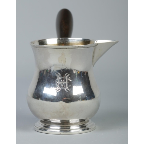 45 - A George III silver brandy pan with turned ebonised handle. Assayed London 1807. Height 8cm. 144g.