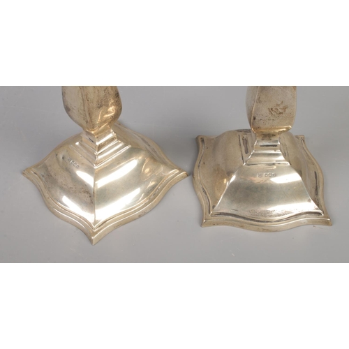 49 - A pair of George V silver candlesticks with detachable nozzles. Assayed Sheffield 1922 by Cooper Bro... 