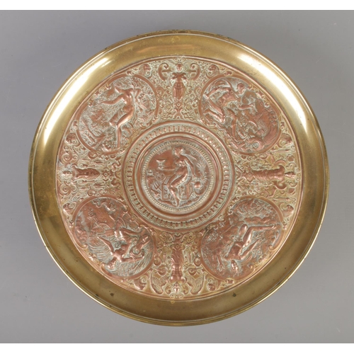 61 - A late 19th century brass and copper tazza. With central panel depicting Temperantia, surrounded by ... 