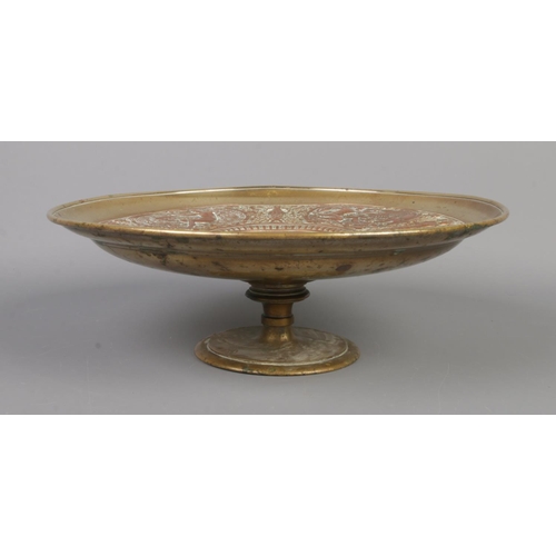 61 - A late 19th century brass and copper tazza. With central panel depicting Temperantia, surrounded by ... 