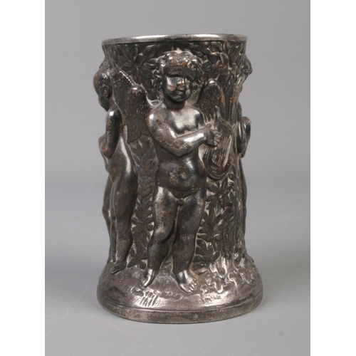 68 - A late 19th/early 20th century white metal brush pot. Decorated in relief with cherubs. Stamped Dini... 