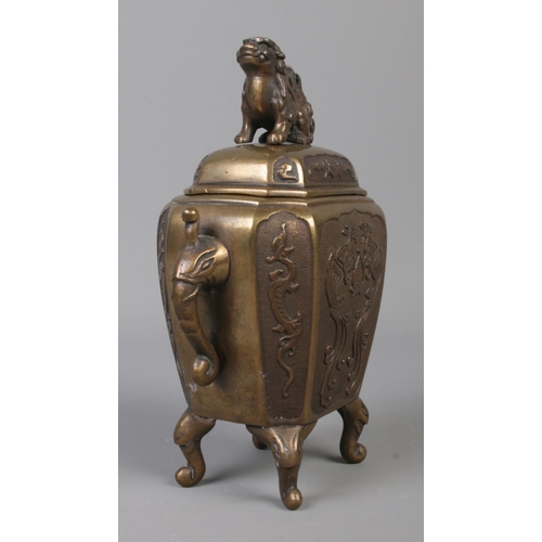 7 - A Chinese bronze censer with cover surmounted by a Foo dog. Having twin elephant mask handles and dr... 