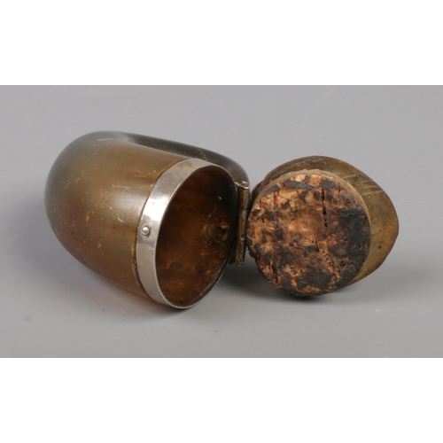 71 - An early 19th century Scottish horn snuff mull with hinged cover and white metal mounts. 10cm x 8cm.