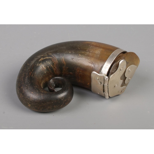 71 - An early 19th century Scottish horn snuff mull with hinged cover and white metal mounts. 10cm x 8cm.