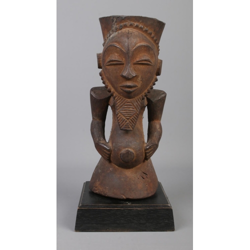 76 - An early to mid 20th century wooden ancestor figure raised on wooden plinth. Probably of the Hemba t... 