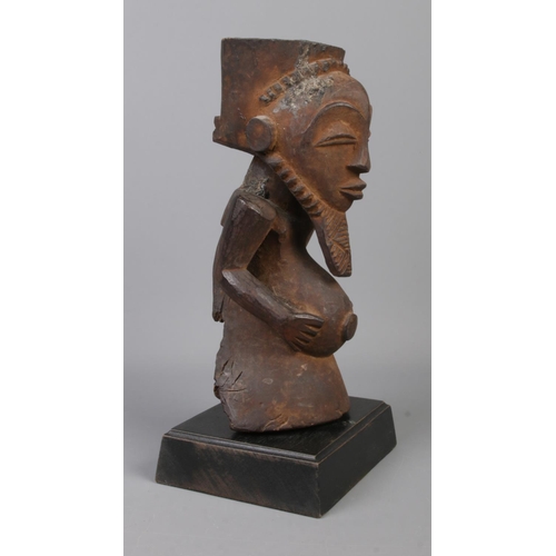 76 - An early to mid 20th century wooden ancestor figure raised on wooden plinth. Probably of the Hemba t... 