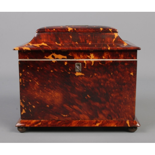 78 - A 19th century tortoise shell tea caddy raised on four bun feet. Having silvered banding and monogra... 