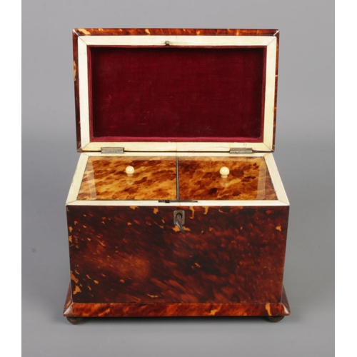 78 - A 19th century tortoise shell tea caddy raised on four bun feet. Having silvered banding and monogra... 