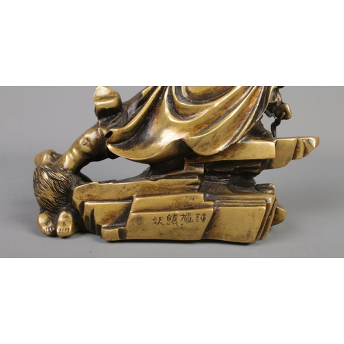 8 - A bronze sculpture of a warrior or Immortal Zhong Kui. Height 22cm.