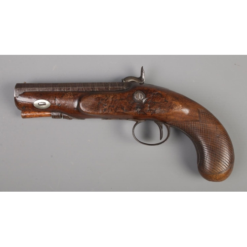 80 - A 19th century percussion cap pistol. Having walnut grip and damascus 11.5cm octagonal barrel. Stamp... 