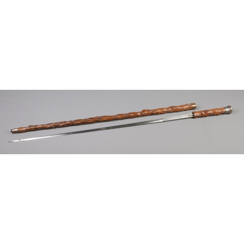 83 - A late 19th/early 20th century Toledo sword stick with white metal pommel. The blade etched with mak... 